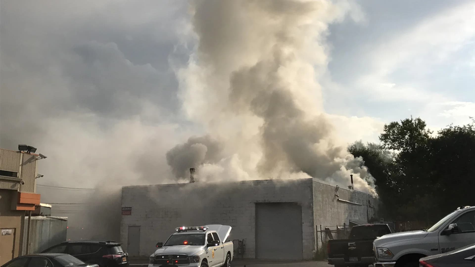 60 firefighters respond to flames at Huntington auto body shop